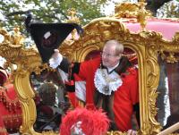The Lord Mayor Alderman David Wooton acknowledges the crowd as the procession files along the Embankment.