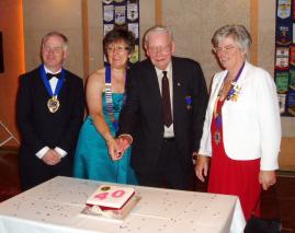 Lion President Judith Colby and Charter Member Alan Brown cut the Newbury cake with the Newbury Mayor and DG Judith