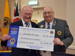 District Governor Ken Staniforth presents PDG Barrie Richardson with a cheque for £4225 for the Freedom Kitbags Charity